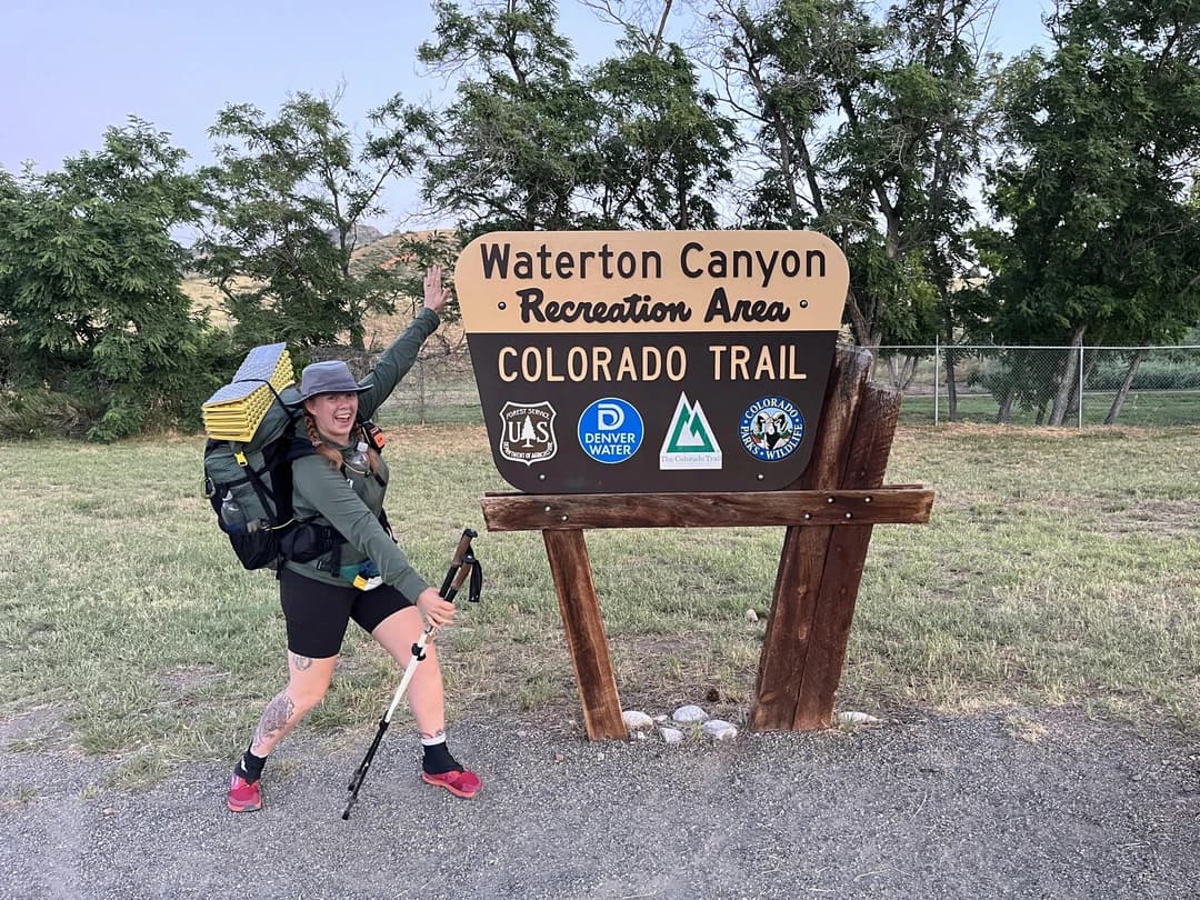 Mackenzie Fresquez at the Colorado Trail sign