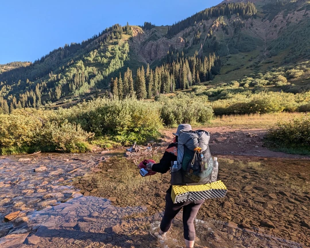 Mackenzie Fresquez by a mountain stream
