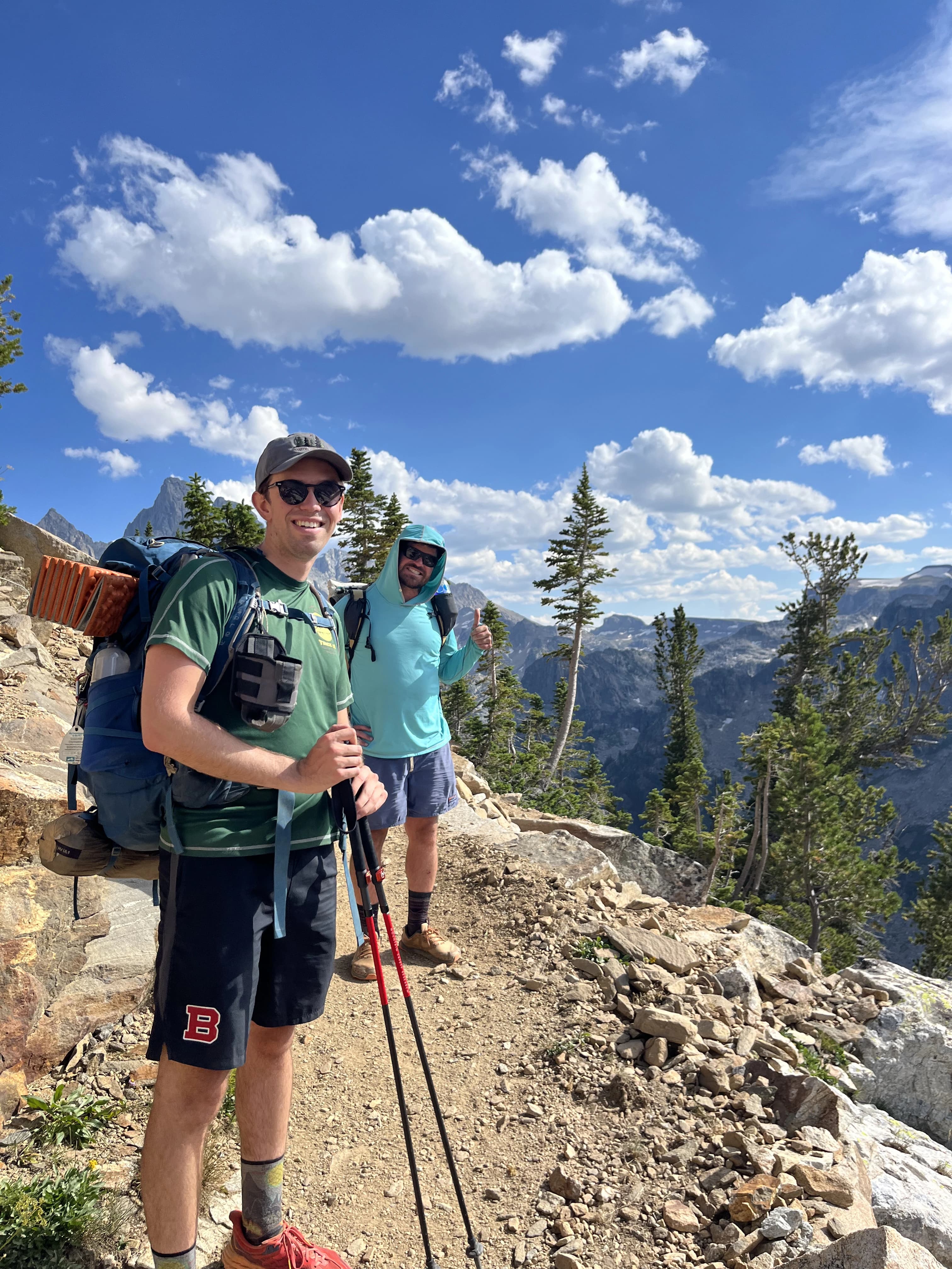 two men on the trail having a good time smiling for the camera
